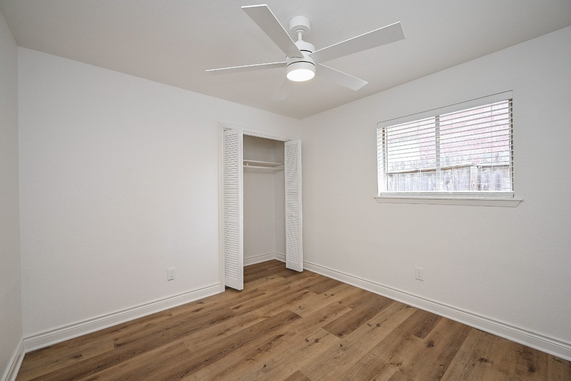 11027 Maize Lane Houston, TX 77041 - Photo 21 of 32 an empty room with wooden floor and windows