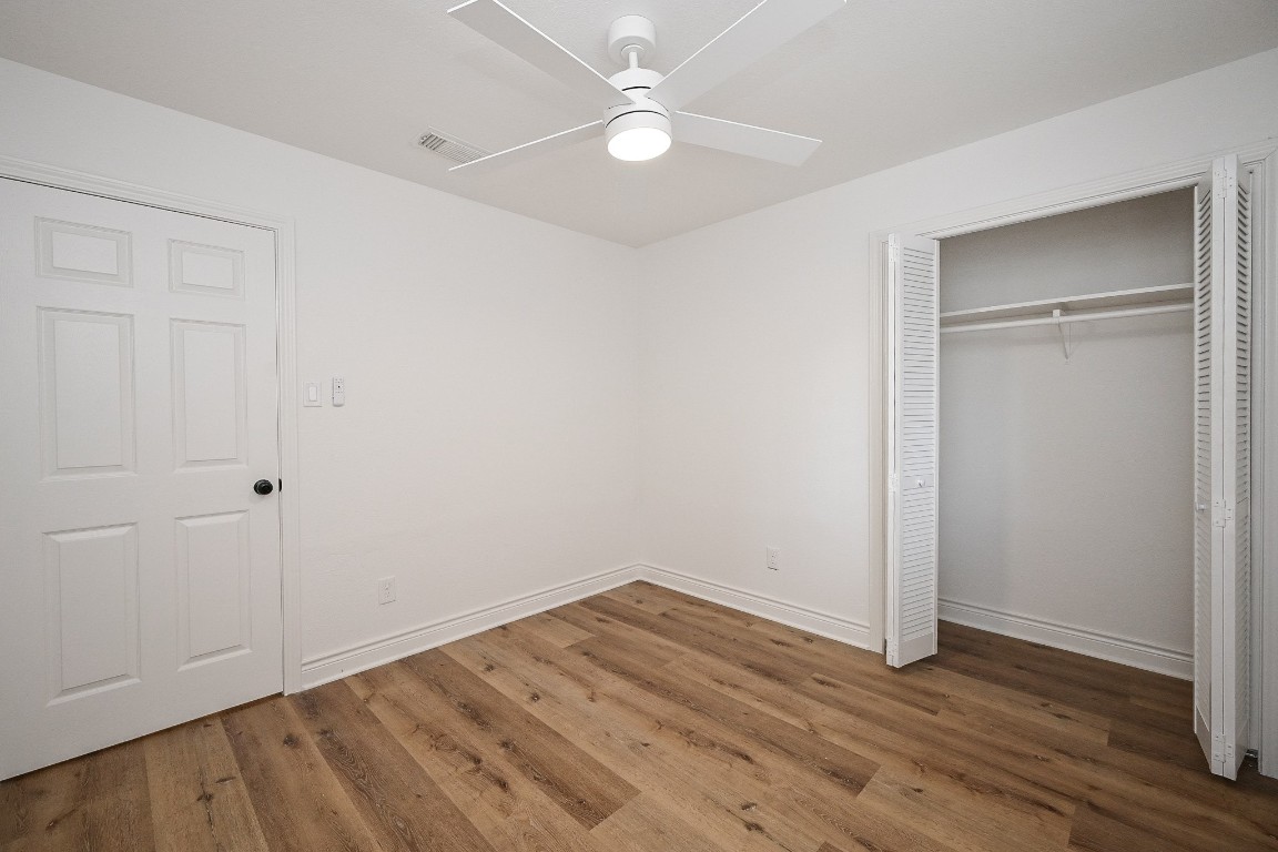 11027 Maize Lane Houston, TX 77041 - Photo 22 of 32 an empty room with wooden floor and fan