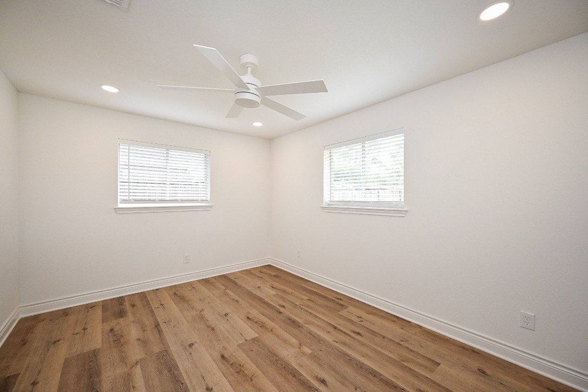 11027 Maize Lane Houston, TX 77041 - Photo 23 of 32 an empty room with a window and ceiling fan