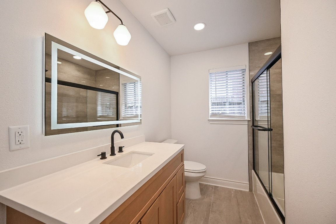 11027 Maize Lane Houston, TX 77041 - Photo 25 of 32 a bathroom with a sink a toilet and a mirror