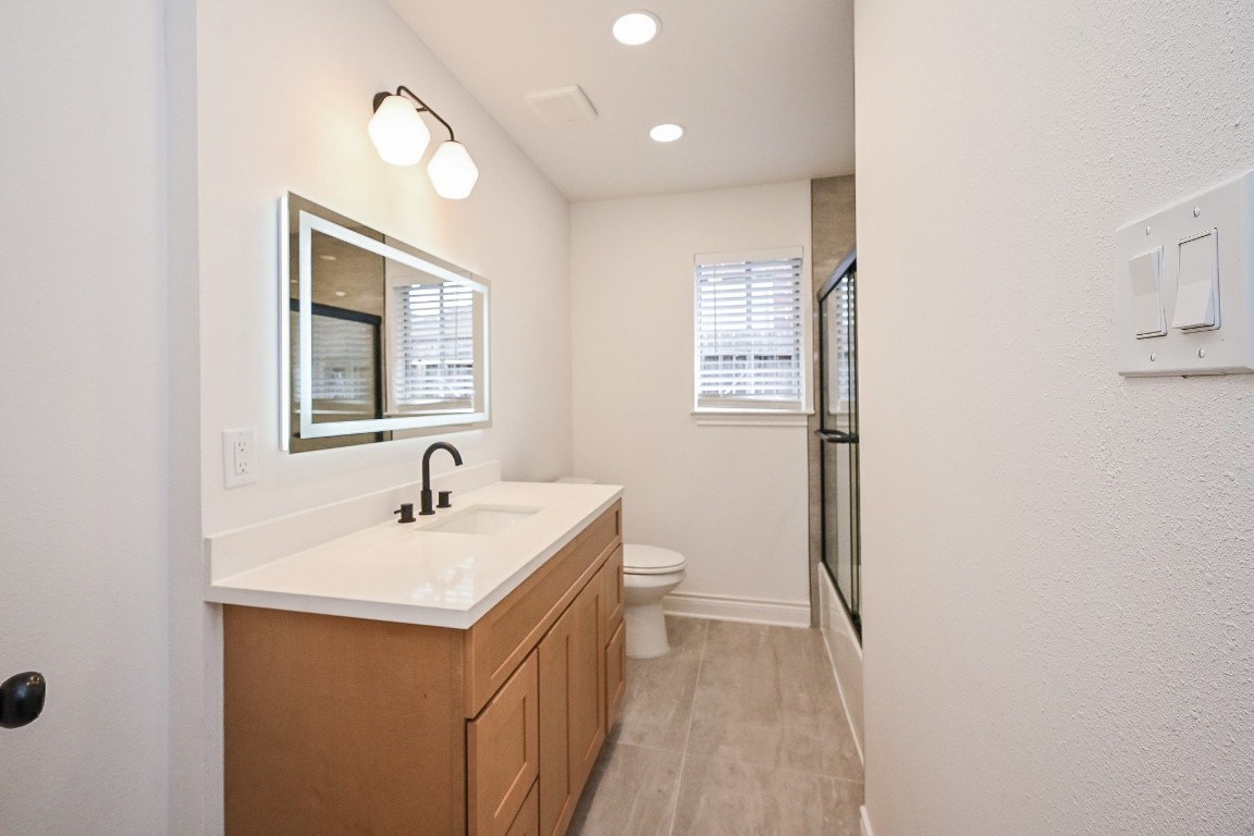 11027 Maize Lane Houston, TX 77041 - Photo 26 of 32 a bathroom with a sink and a mirror