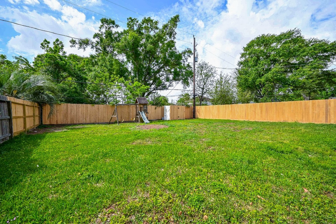 11027 Maize Lane Houston, TX 77041 - Photo 31 of 32 a view of yard with swimming pool and trees in the background