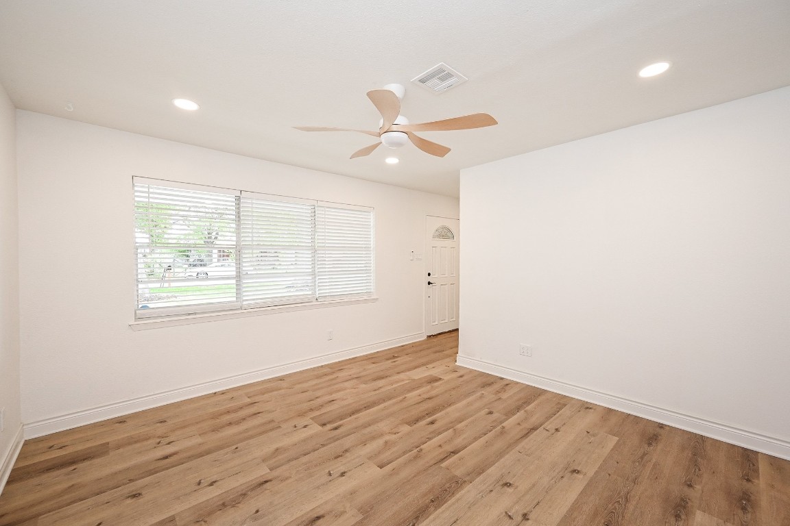 11027 Maize Lane Houston, TX 77041 - Photo 5 of 32 an empty room with wooden floor ceiling fan and windows