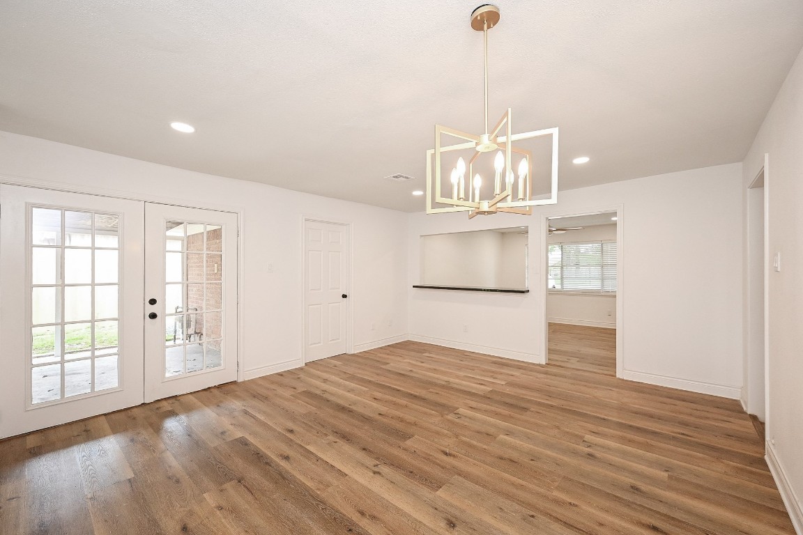 11027 Maize Lane Houston, TX 77041 - Photo 7 of 32 a view of an empty room with wooden floor and a window