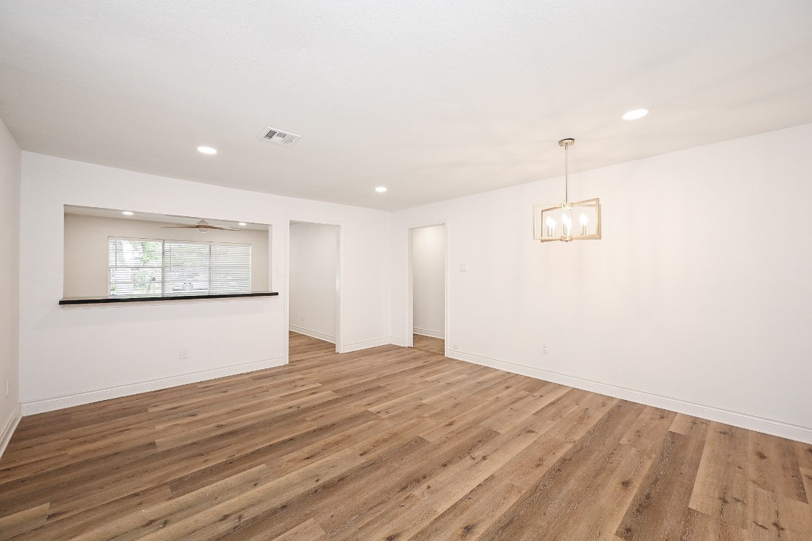 11027 Maize Lane Houston, TX 77041 - Photo 9 of 32 a view of an empty room with wooden floor and a window