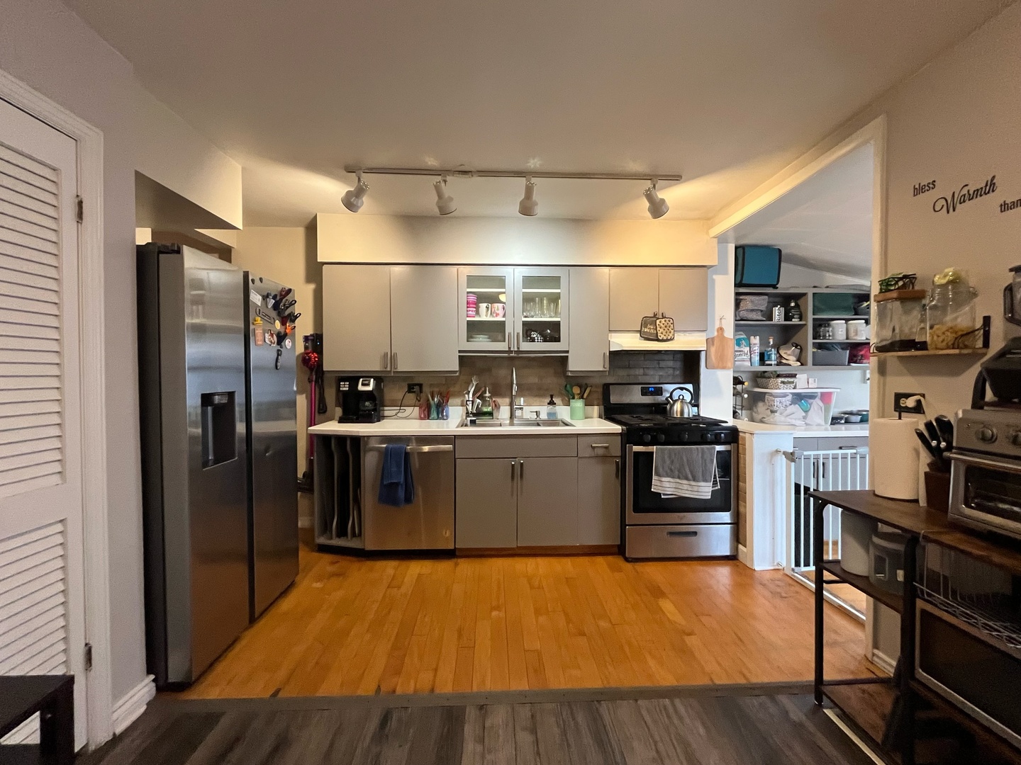 2950 Des Plaines Avenue, Unit 2950 North Riverside, IL 60546 - Photo 6 of 11 a kitchen with stainless steel appliances wooden floor sink and refrigerator