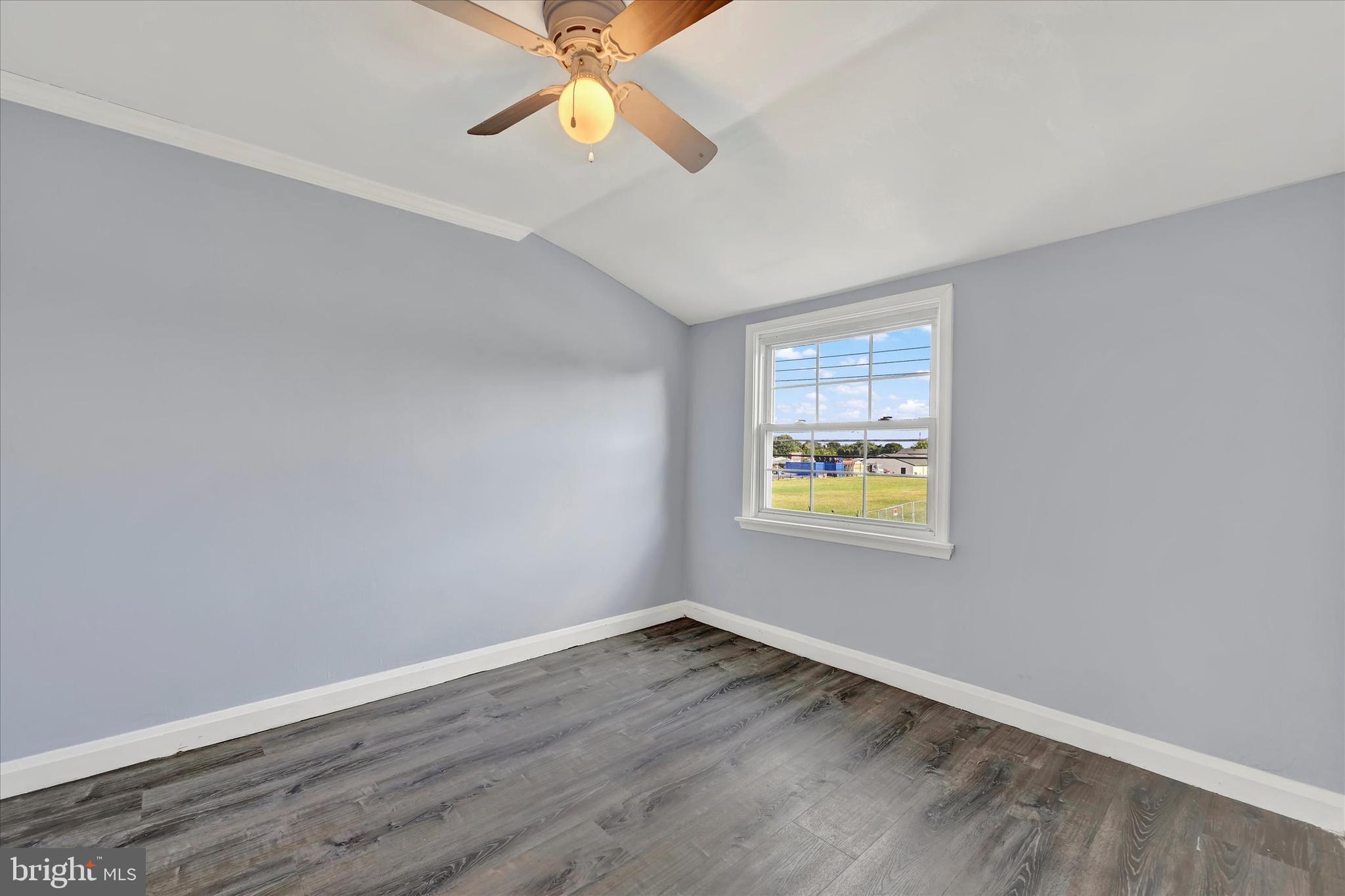 7954 Kavanagh Road Baltimore, MD 21222 - Photo 12 of 16 an empty room with a window and wooden floor