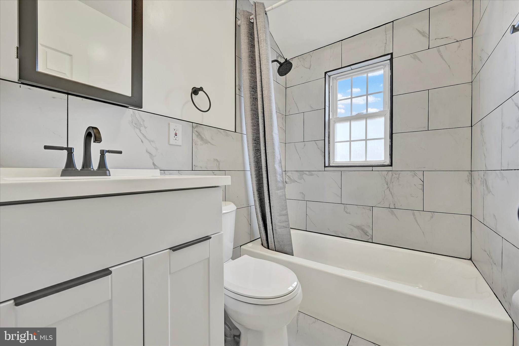 7954 Kavanagh Road Baltimore, MD 21222 - Photo 13 of 16 a bathroom with a sink a toilet and shower