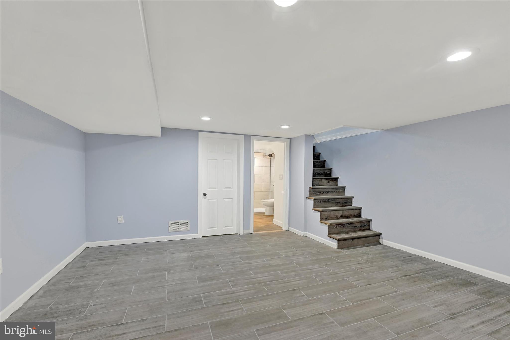 7954 Kavanagh Road Baltimore, MD 21222 - Photo 14 of 16 a view of room with stairs and wooden floor