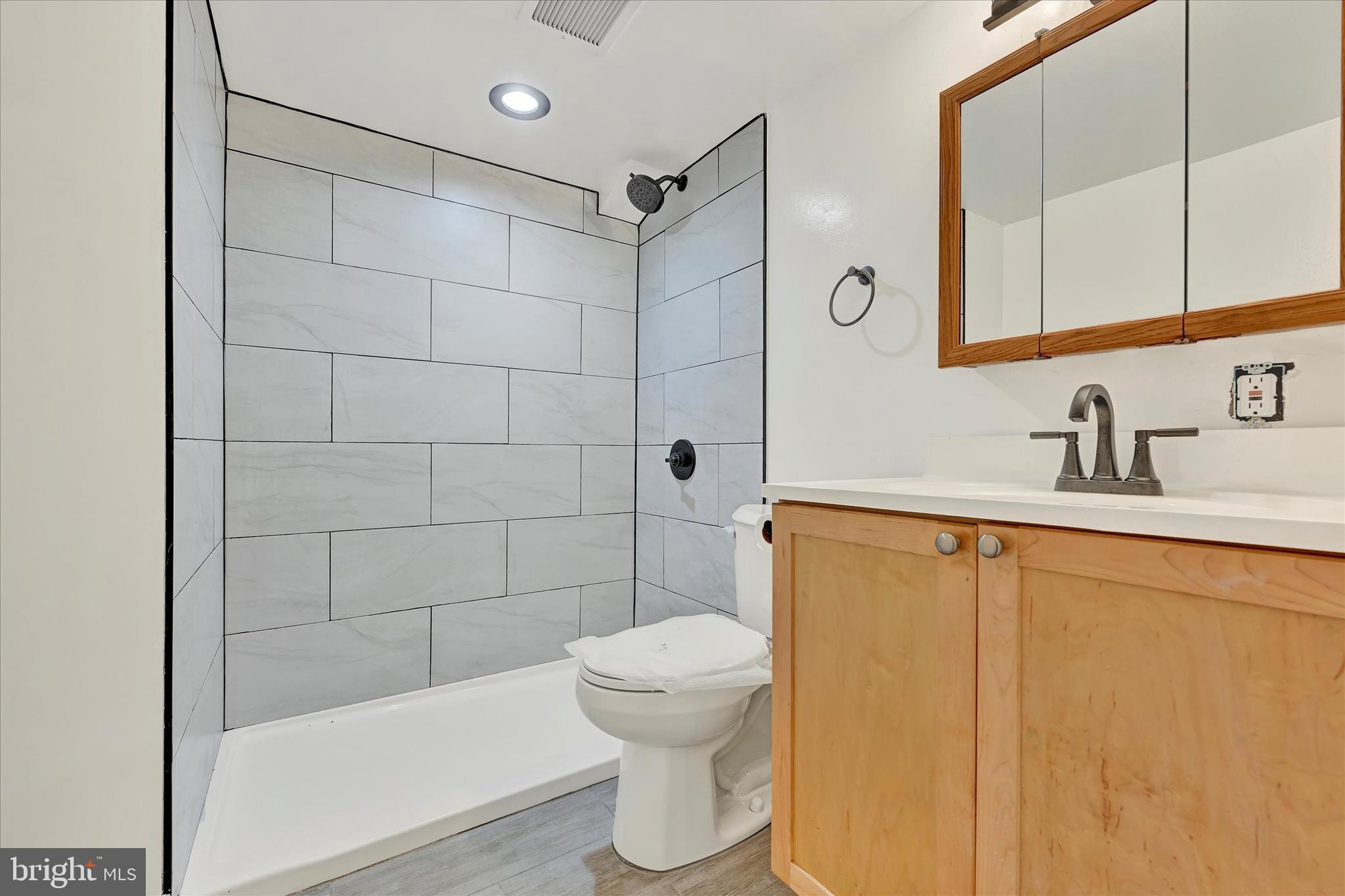 7954 Kavanagh Road Baltimore, MD 21222 - Photo 15 of 16 a bathroom with a sink a toilet and shower