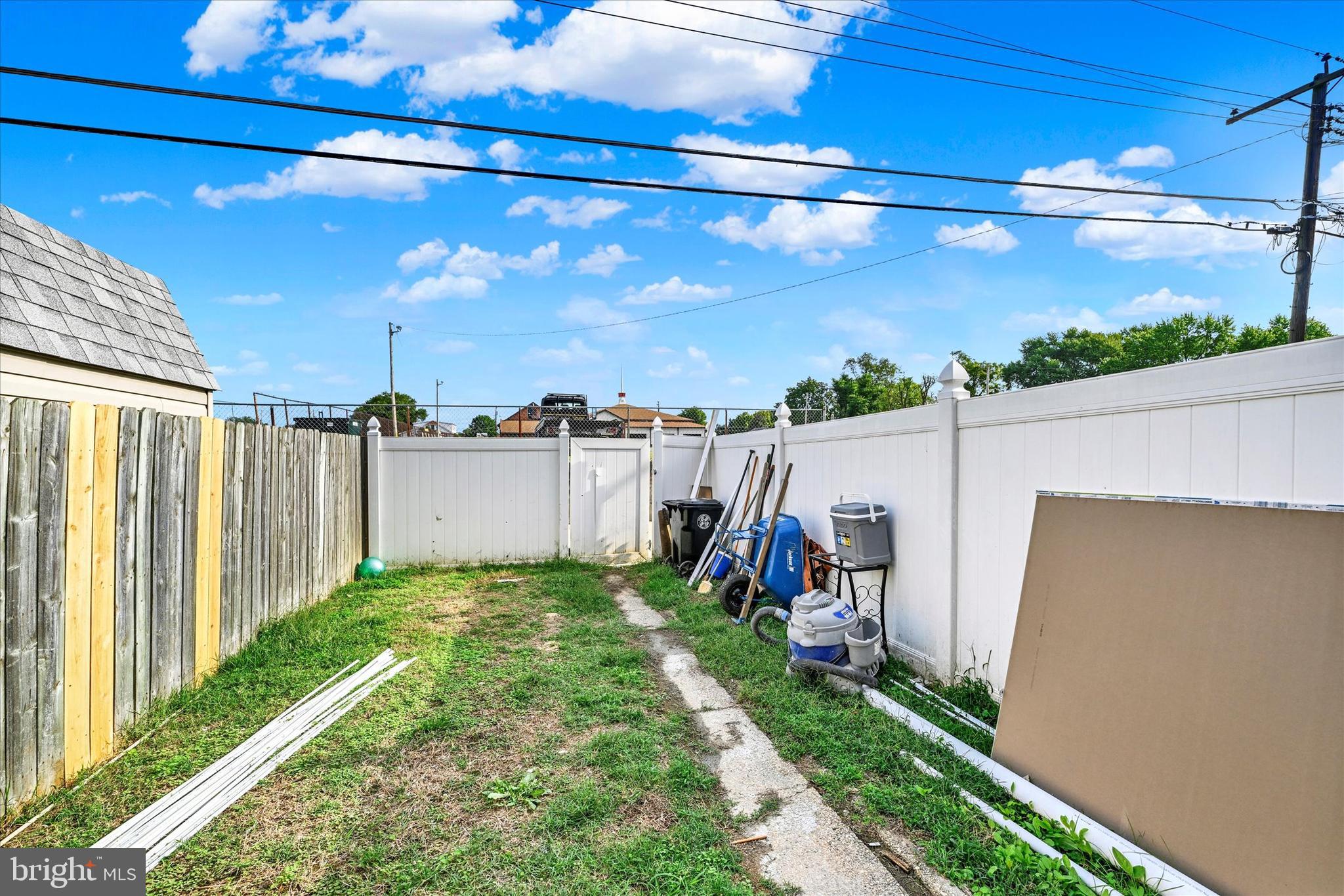 7954 Kavanagh Road Baltimore, MD 21222 - Photo 16 of 16 a view of a yard with wooden fence