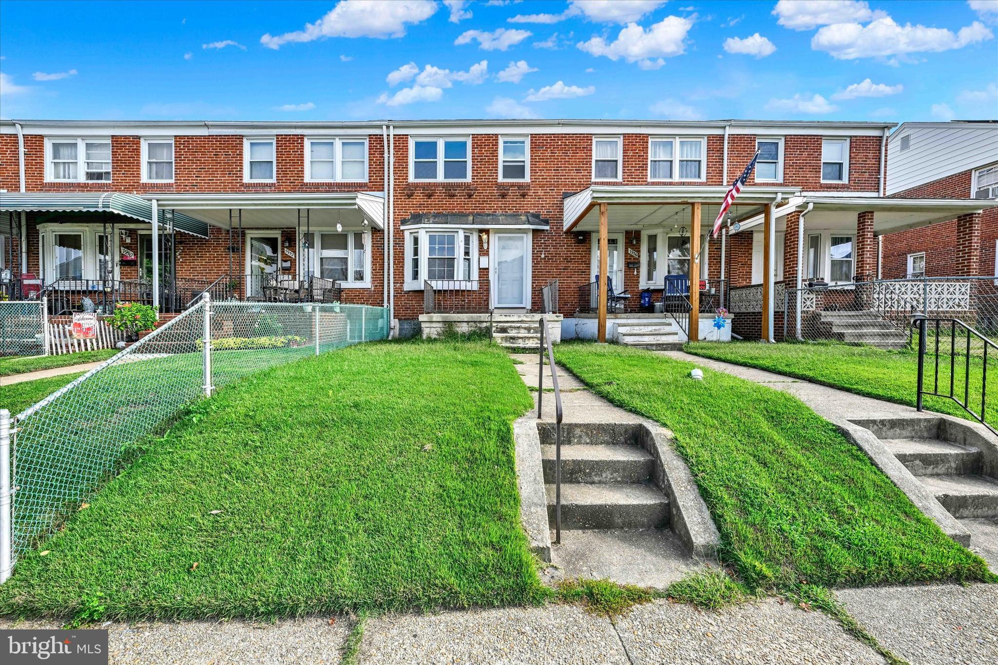 7954 Kavanagh Road Baltimore, MD 21222 - Photo 2 of 16 front view of a brick house with a yard