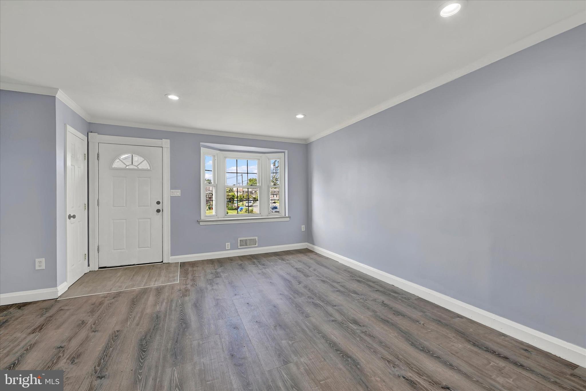 7954 Kavanagh Road Baltimore, MD 21222 - Photo 3 of 16 wooden floor in an empty room with a window