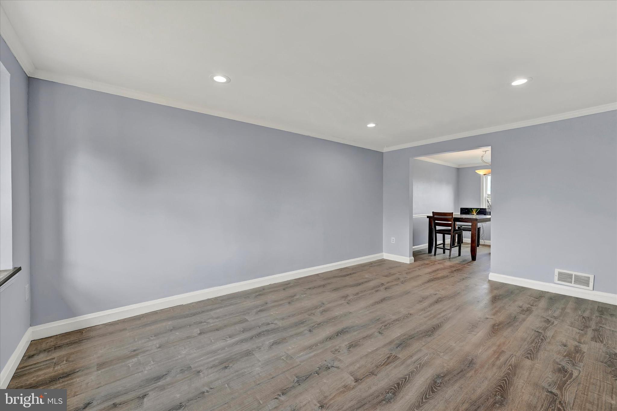 7954 Kavanagh Road Baltimore, MD 21222 - Photo 5 of 16 a view of an empty room with wooden floor