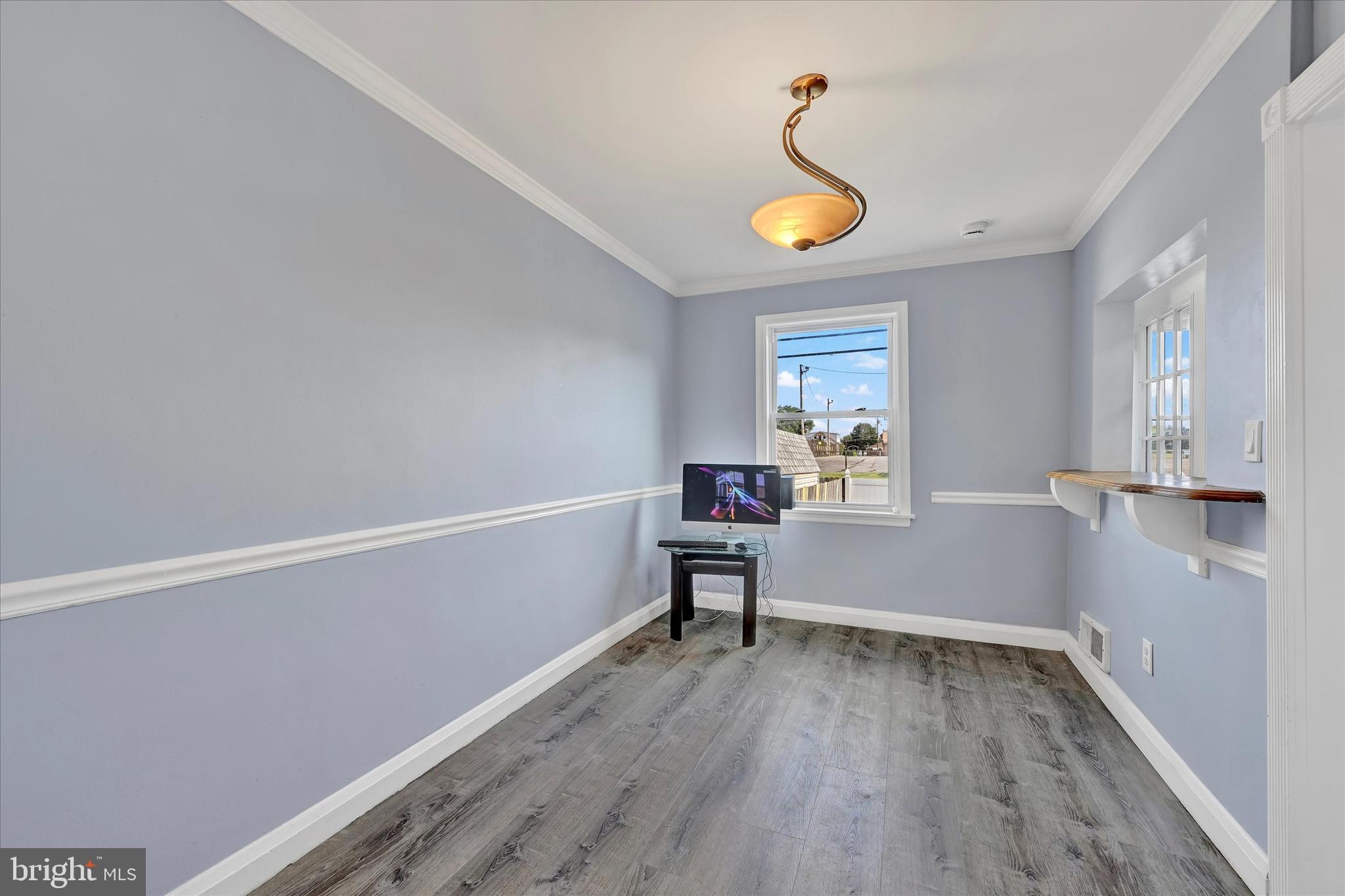 7954 Kavanagh Road Baltimore, MD 21222 - Photo 6 of 16 a view of a livingroom with wooden floor and a window