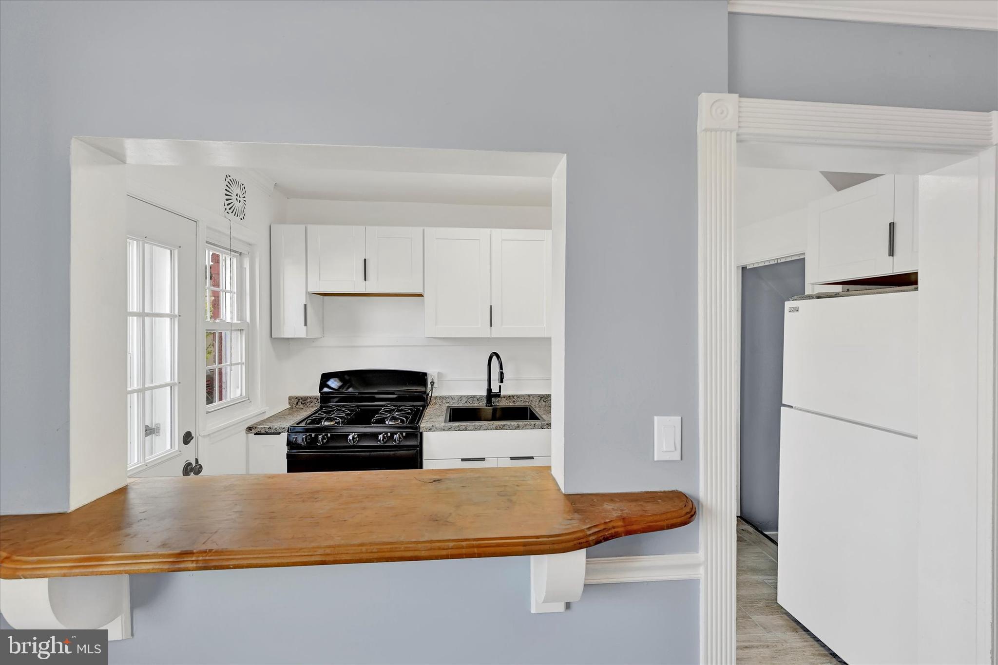 7954 Kavanagh Road Baltimore, MD 21222 - Photo 7 of 16 a kitchen with a refrigerator and a stove