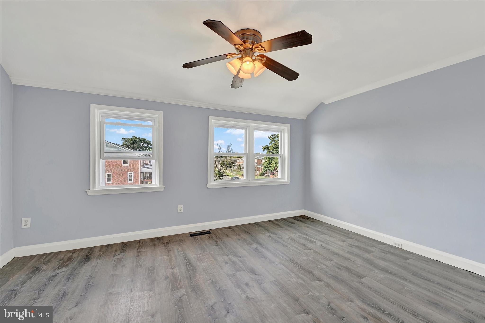 7954 Kavanagh Road Baltimore, MD 21222 - Photo 10 of 16 a view of an empty room with wooden floor and a window