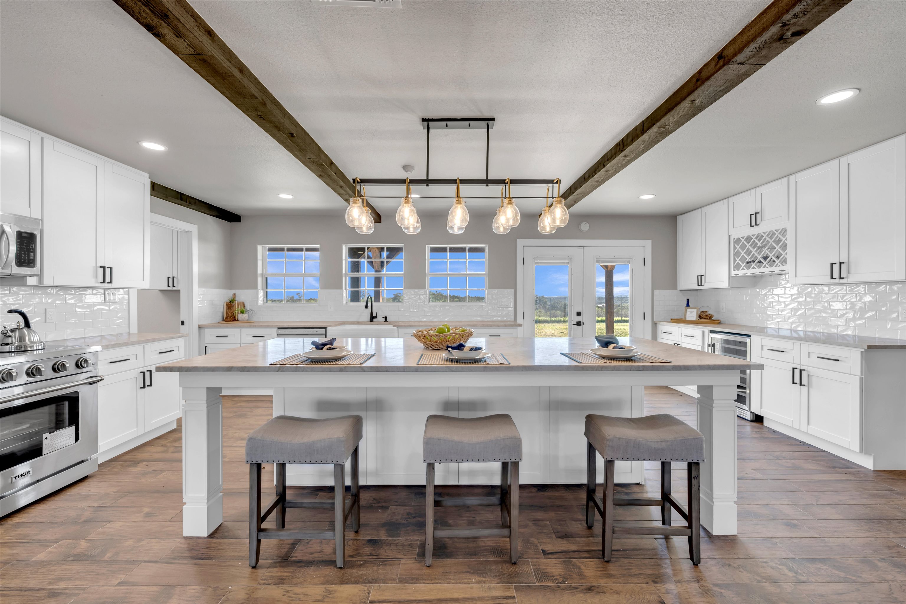 941 County Road 402 Marble Falls, TX 78654 - Photo 7 of 30 a kitchen with stainless steel appliances granite countertop a table chairs sink and cabinets