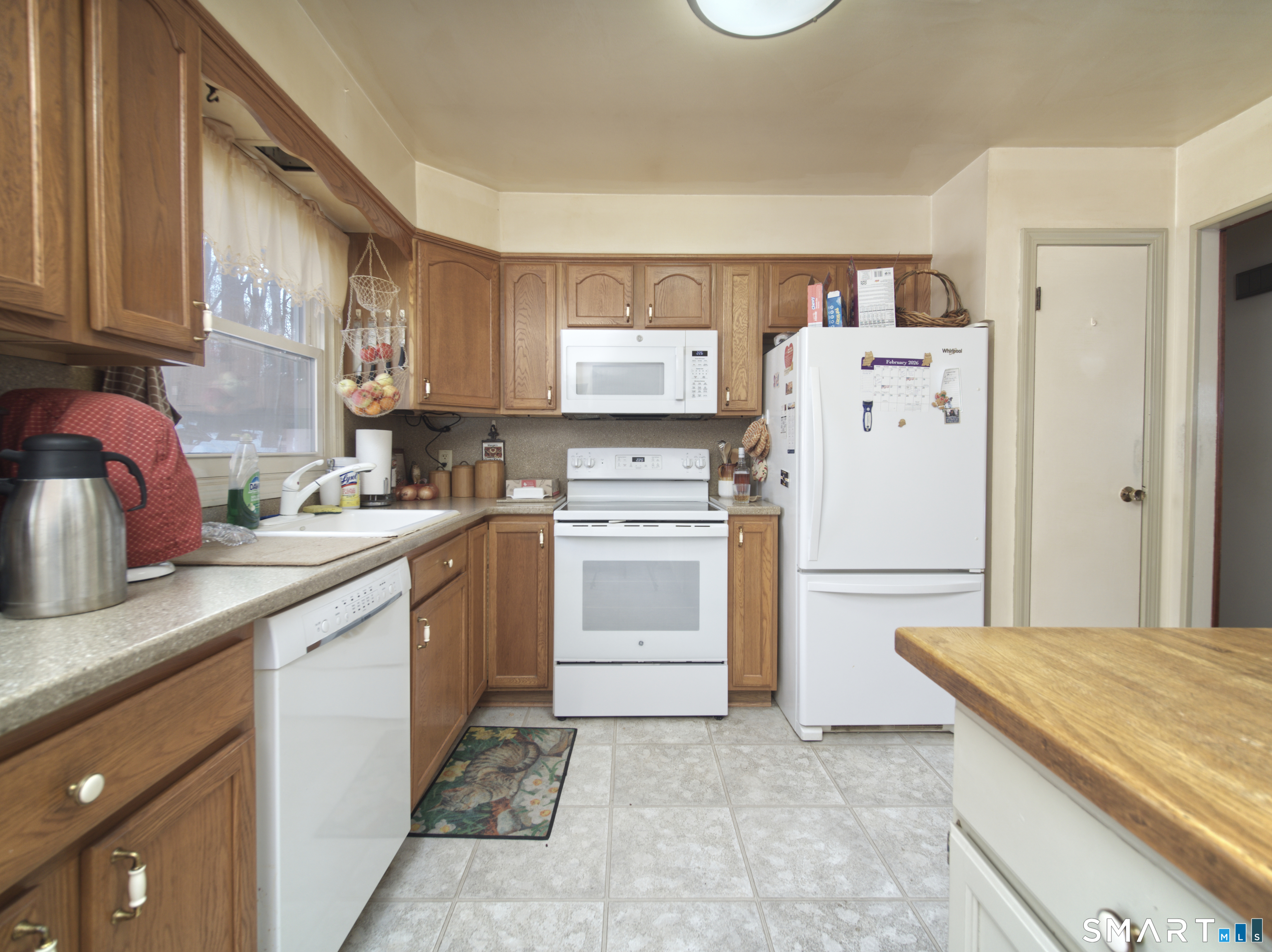 268 Chestnut Land Road New Milford, CT 06776 - Photo 18 of 20 a kitchen with a white stove refrigerator and cabinets