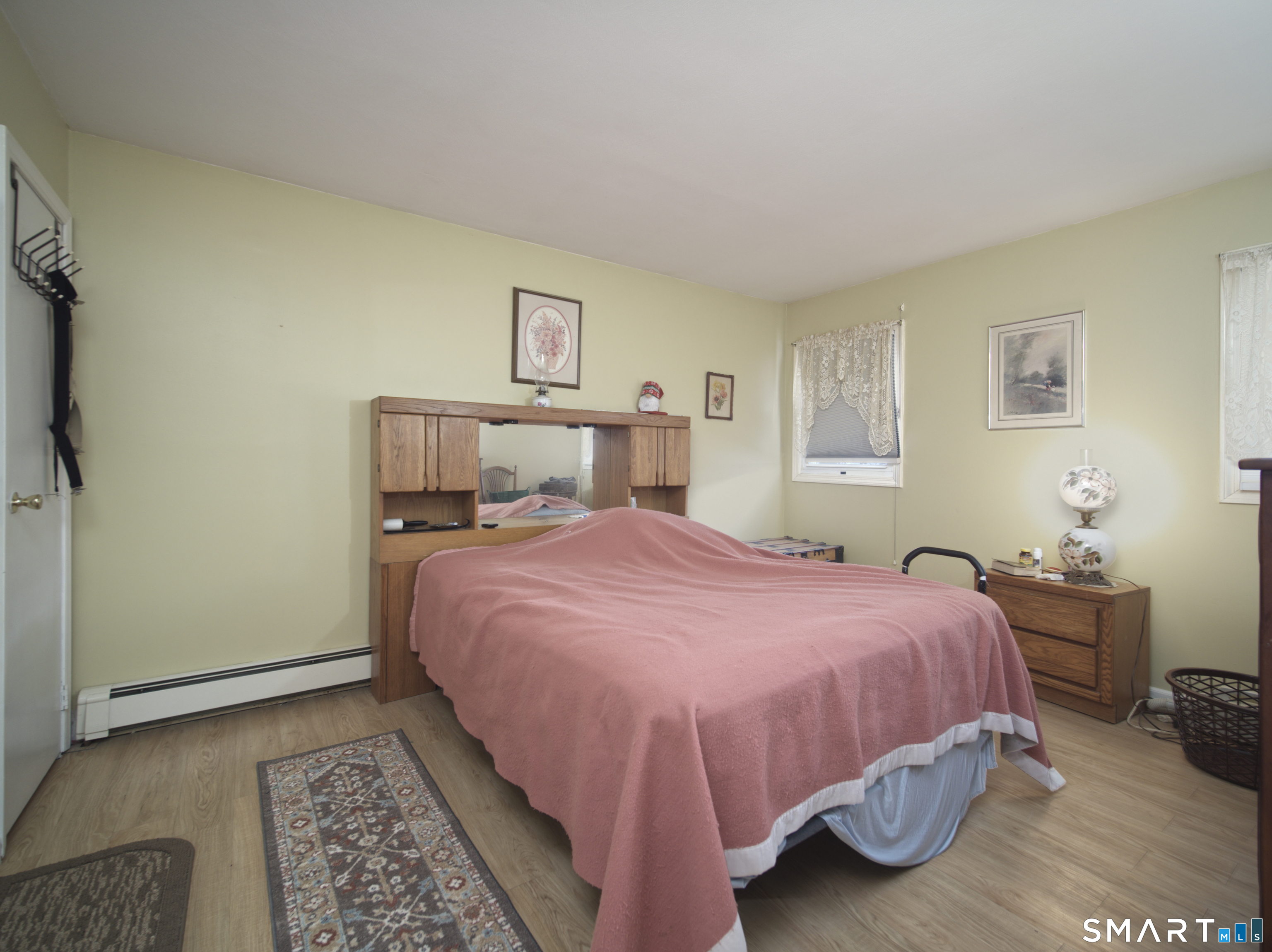268 Chestnut Land Road New Milford, CT 06776 - Photo 10 of 20 a bedroom with a bed and wooden floor