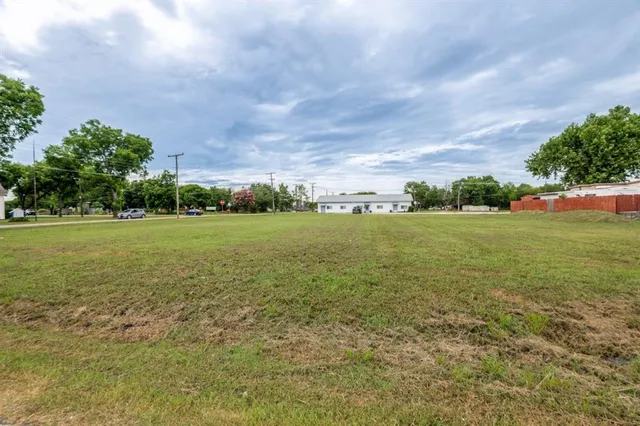 a view of a field with an ocean