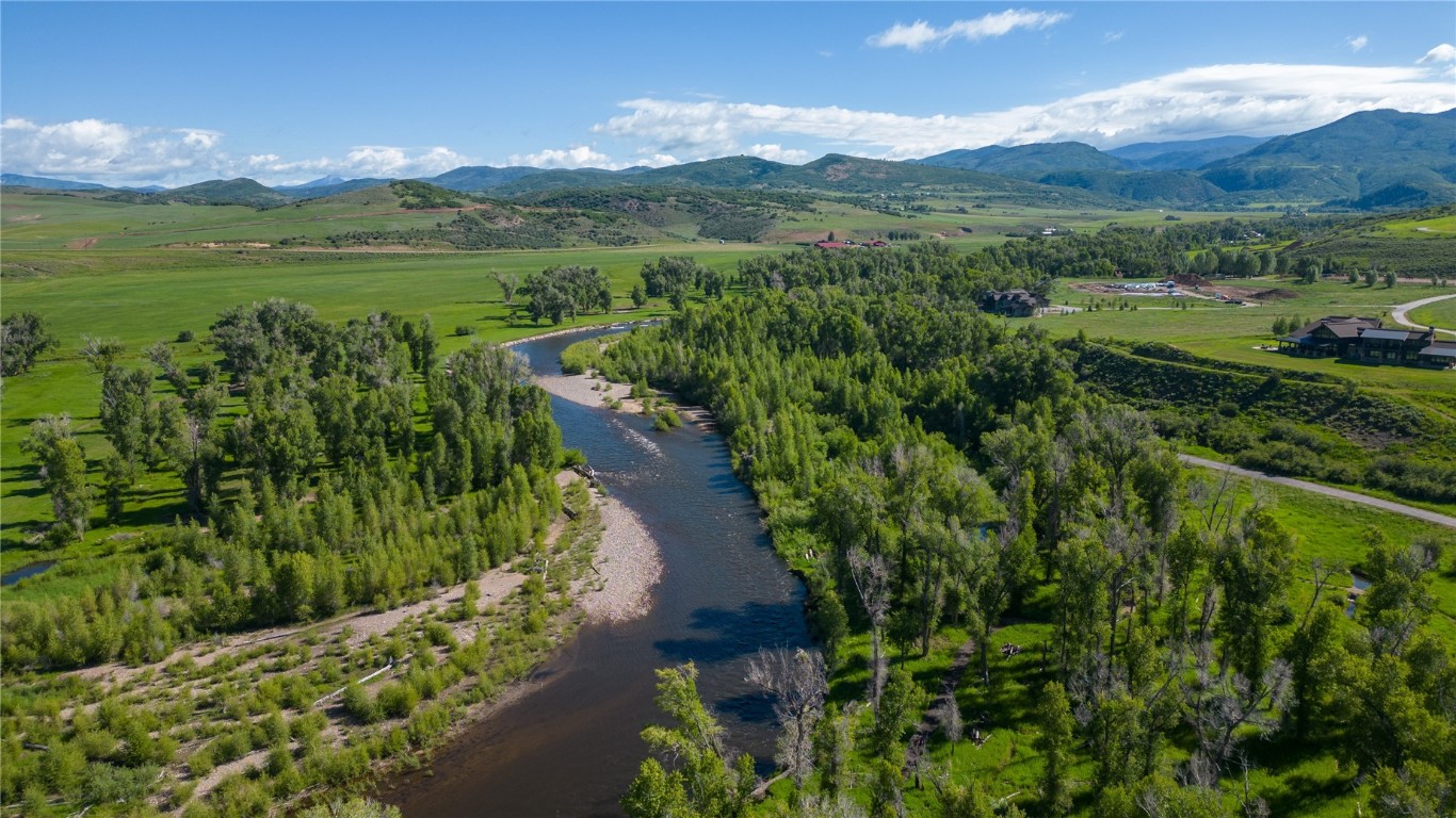27105 Cowboy Up Road Steamboat Springs, CO 80487 - Photo 3 of 28 a view of a lake with a mountain in the background