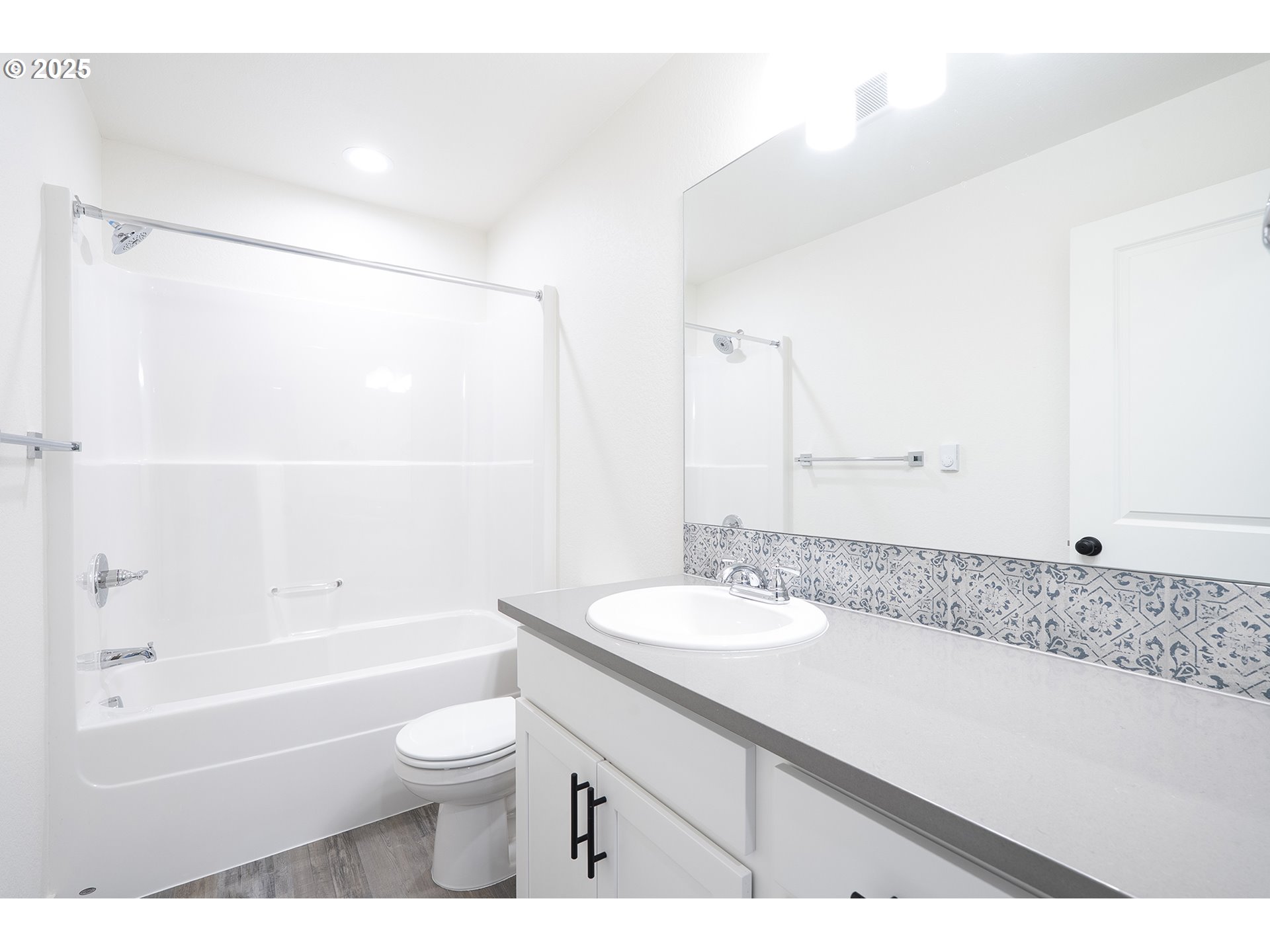 14722 Southeast Powell Boulevard Portland, OR 97236 - Photo 17 of 20 a bathroom with a granite countertop sink a toilet and bathtub
