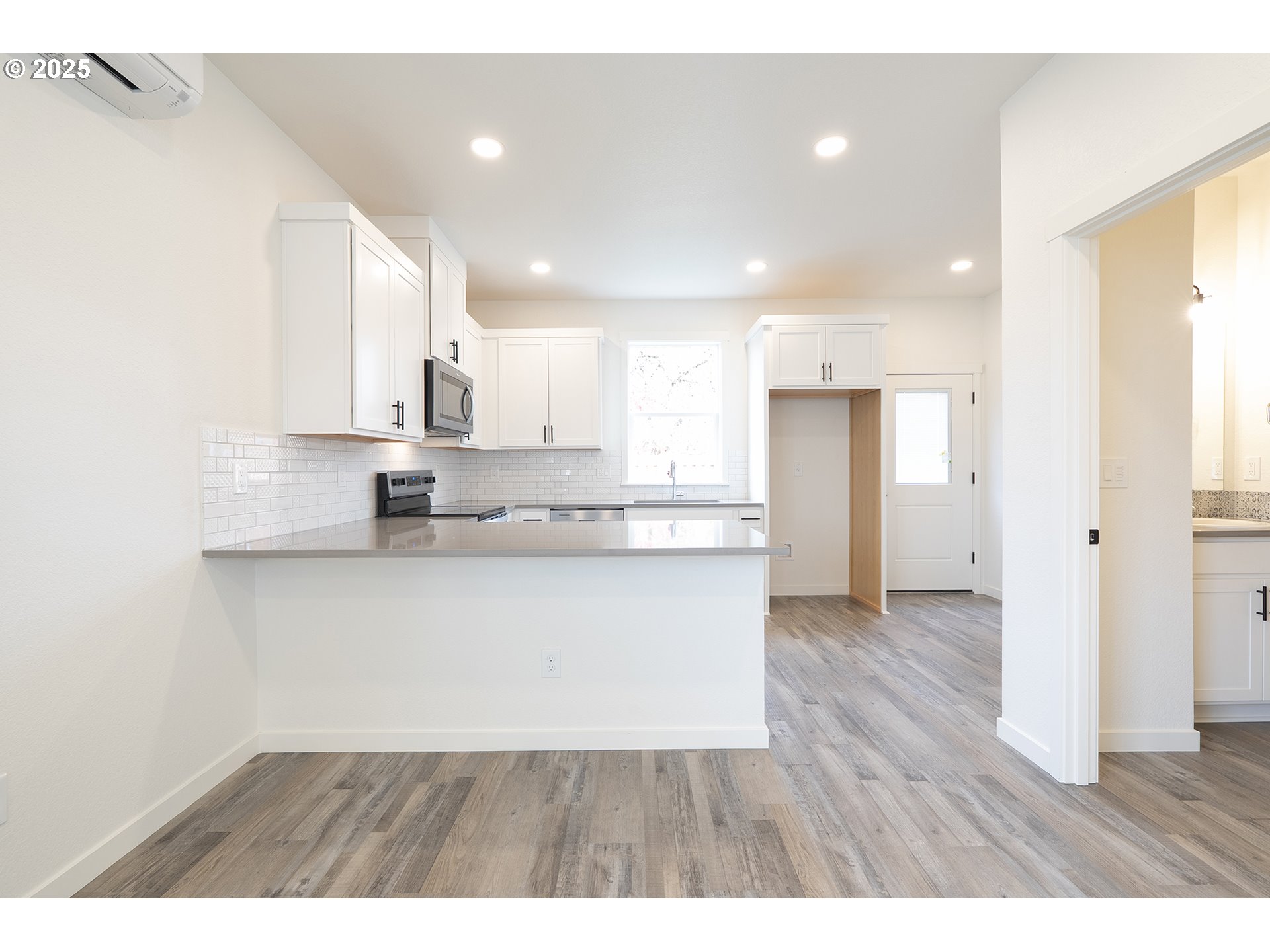 14722 Southeast Powell Boulevard Portland, OR 97236 - Photo 6 of 20 a open kitchen with white cabinets and stainless steel appliances