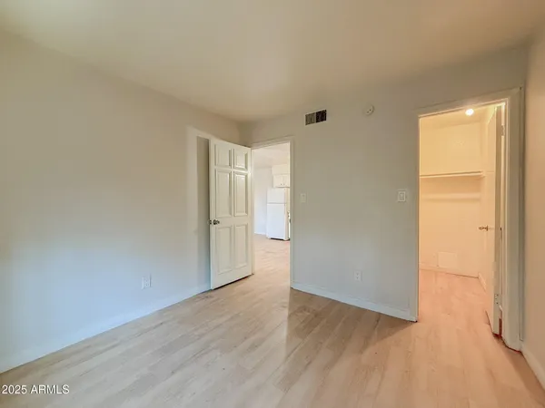 a view of an empty room and wooden floor