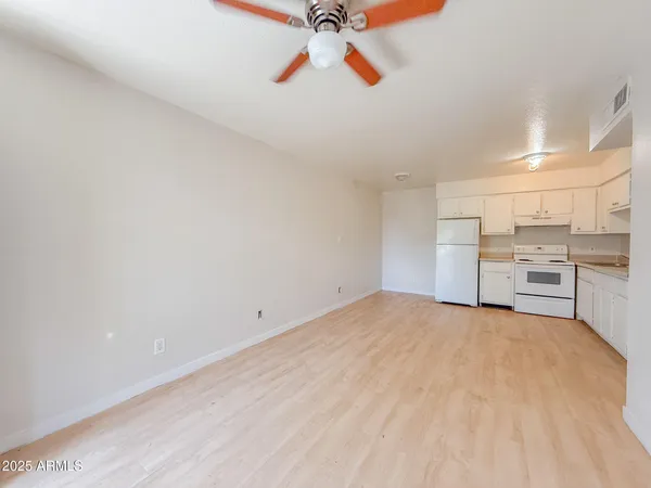 a view of a kitchen with a sink and cabinets