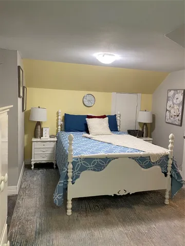 a bedroom with a bed and a night stand