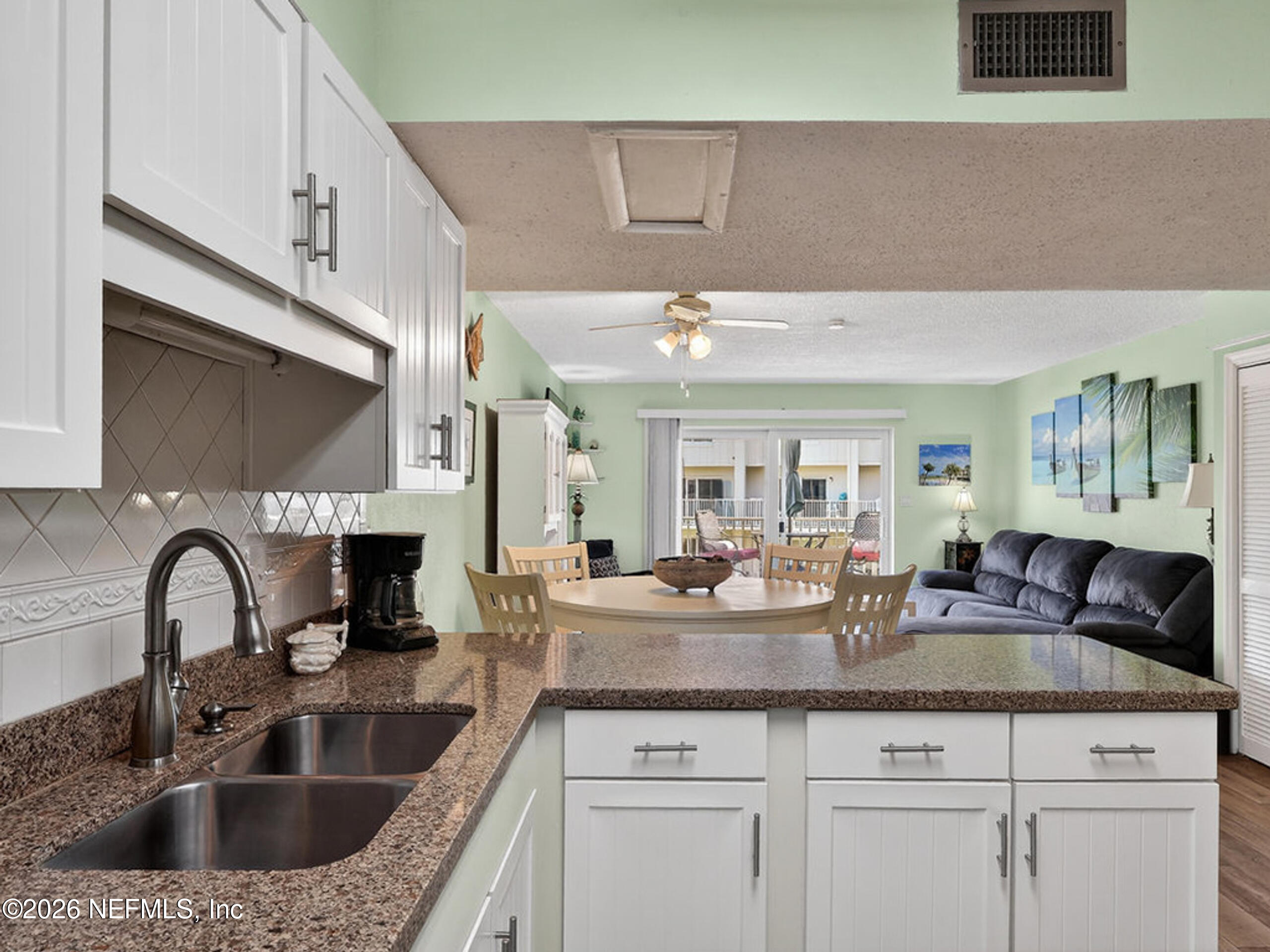 1 Ocean Trace Road, Unit 230 St. Augustine Beach, FL 32080 - Photo 7 of 50 a kitchen with granite countertop a sink stainless steel appliances and cabinets