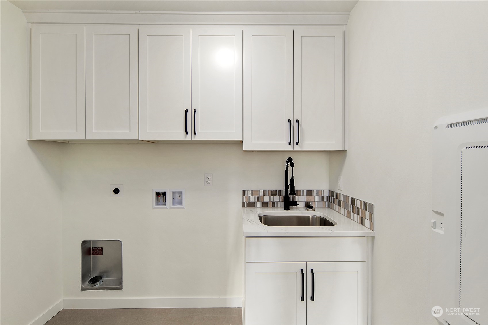 105 179th Place Southwest Bothell, WA 98012 - Photo 20 of 24 a kitchen with white cabinets and a sink
