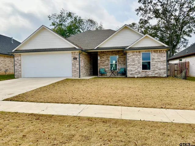 a view of a house with a yard and garage