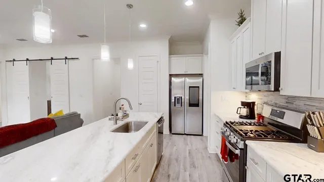 a kitchen that has a sink and a stove