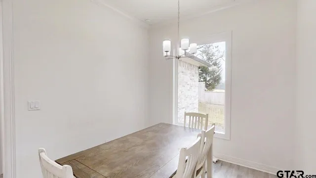 a view of a dining room with furniture wooden floor and a chandelier
