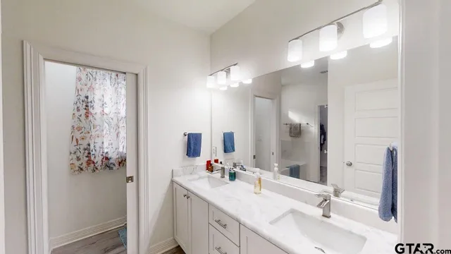 a bathroom with a double vanity sink mirror and double