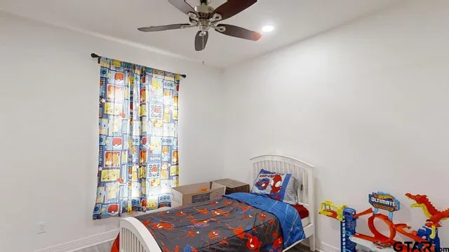 a bedroom with a bed and a chandelier