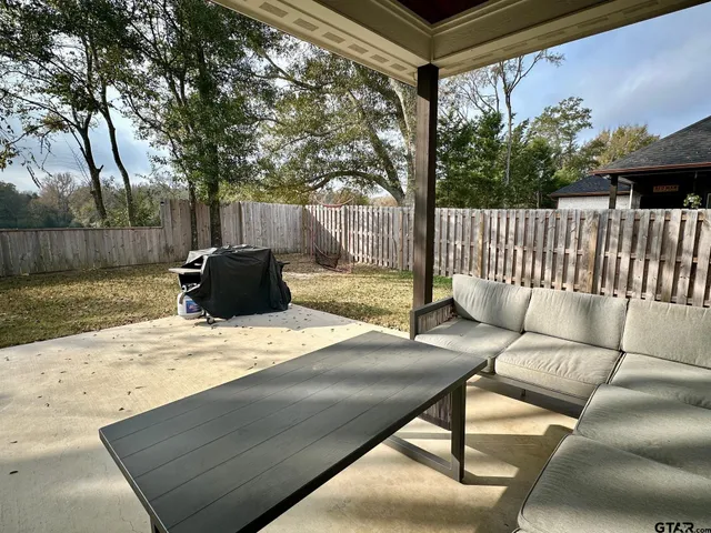a backyard of a house with table and chairs