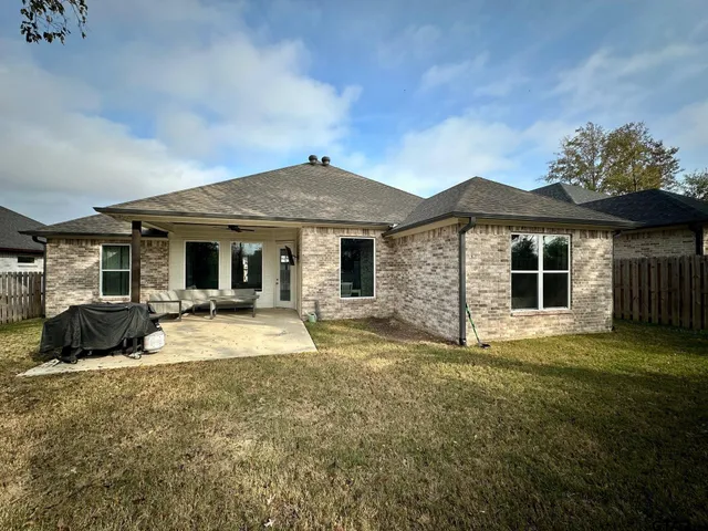 a front view of a house with a garden and yard