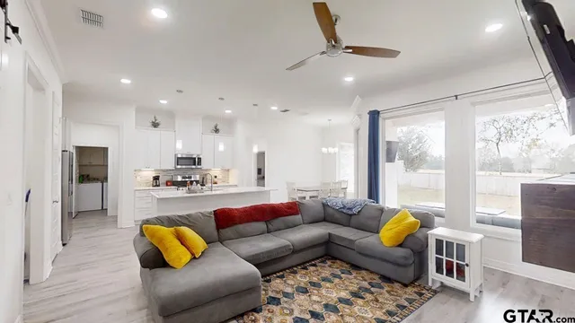 a living room with furniture and a large window