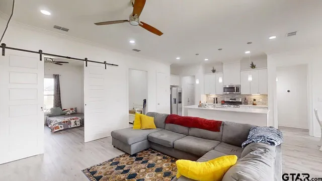 a living room with furniture and a chandelier