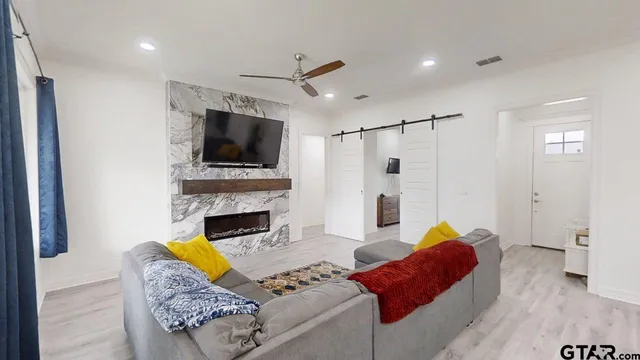 a living room with furniture and a fireplace