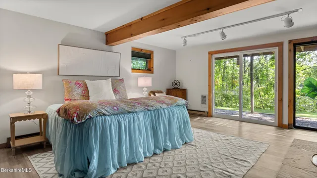 a bedroom with a large bed and a night stand