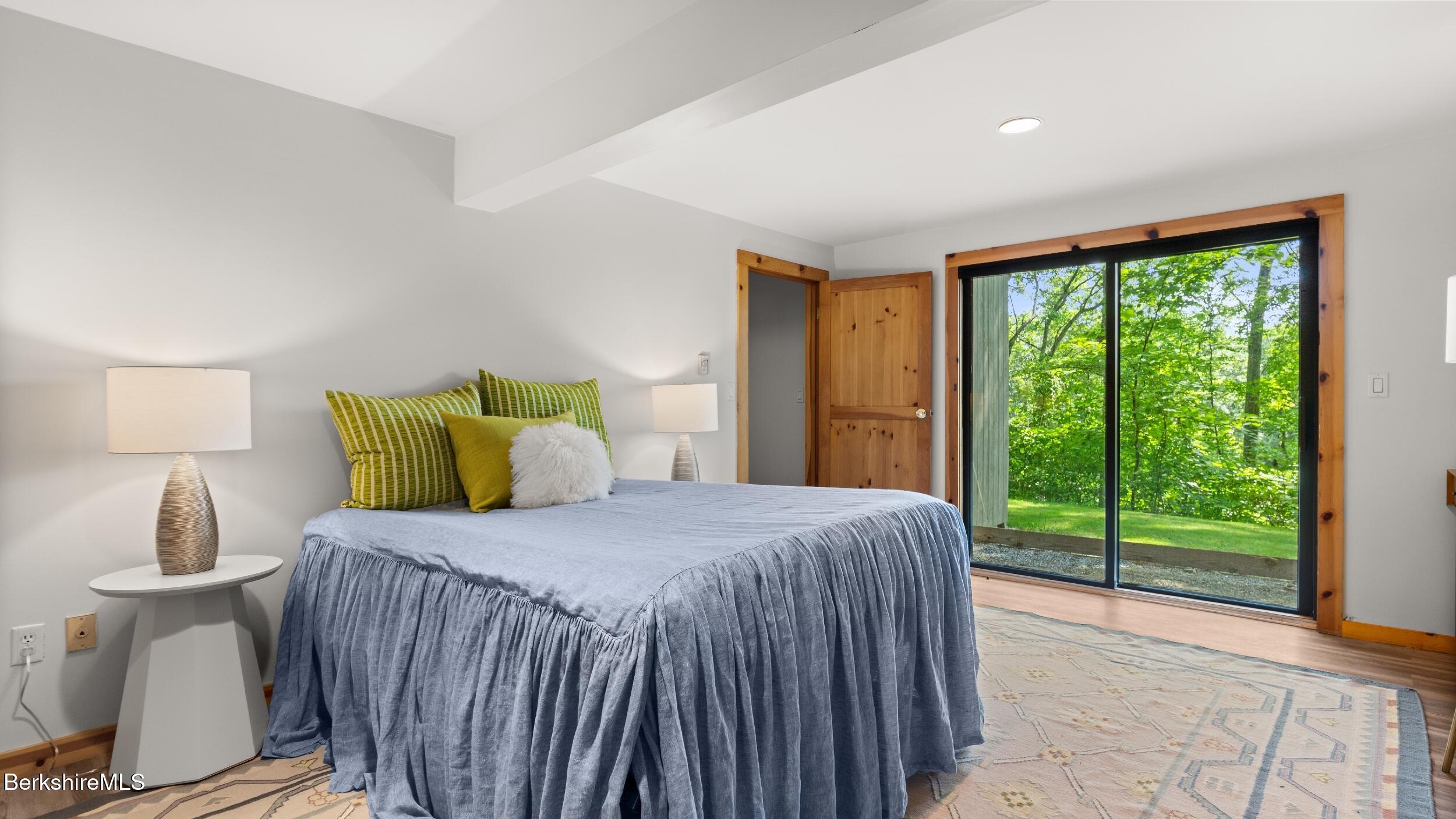 85 Main Road Monterey, MA 01230 - Photo 14 of 32 a bedroom with a balcony a bed and a lamp