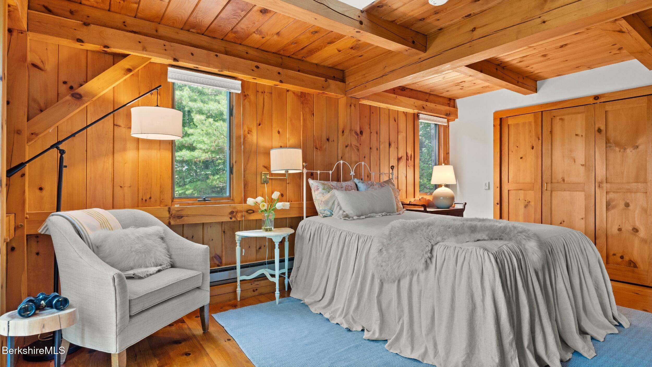 85 Main Road Monterey, MA 01230 - Photo 23 of 32 a spacious bedroom with a bed and a couch