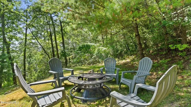 a view of backyard with patio and outdoor seating