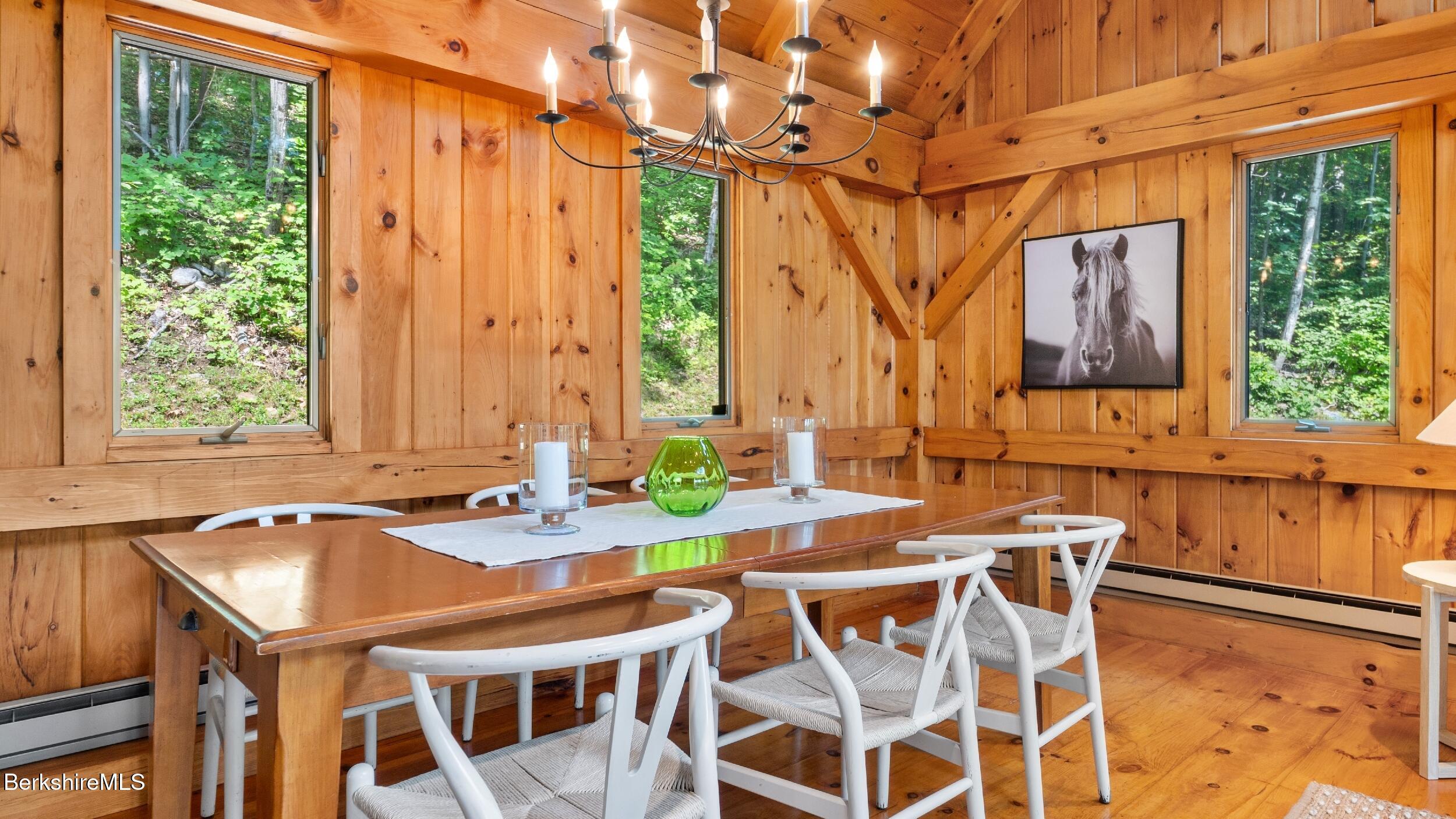 85 Main Road Monterey, MA 01230 - Photo 9 of 32 a view of a patio with table and chairs with wooden floor