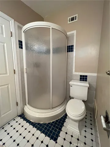 a bathroom with a toilet and a shower