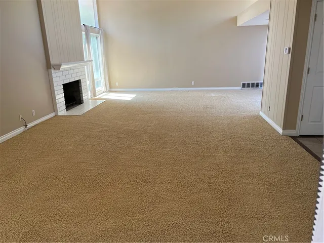 a view of empty room with fireplace